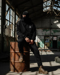 a men site on a drum wear ninja balaclava hoodie with long brown boat