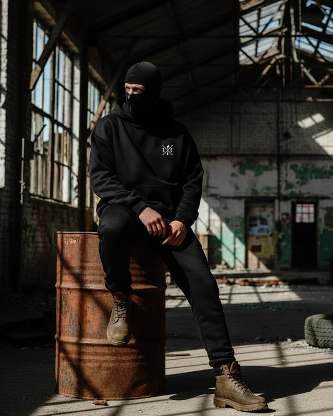 a men site on a drum wear ninja balaclava hoodie with long brown boat