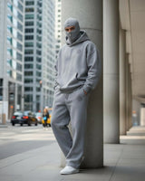 a men stand on the street of Dubai and wear grey ninja balclava hoodie with mask